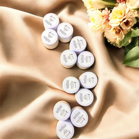 Multiple small containers on a textured surface with flowers in the background